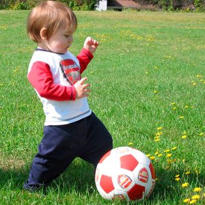 Toddler kicking a soccer ball